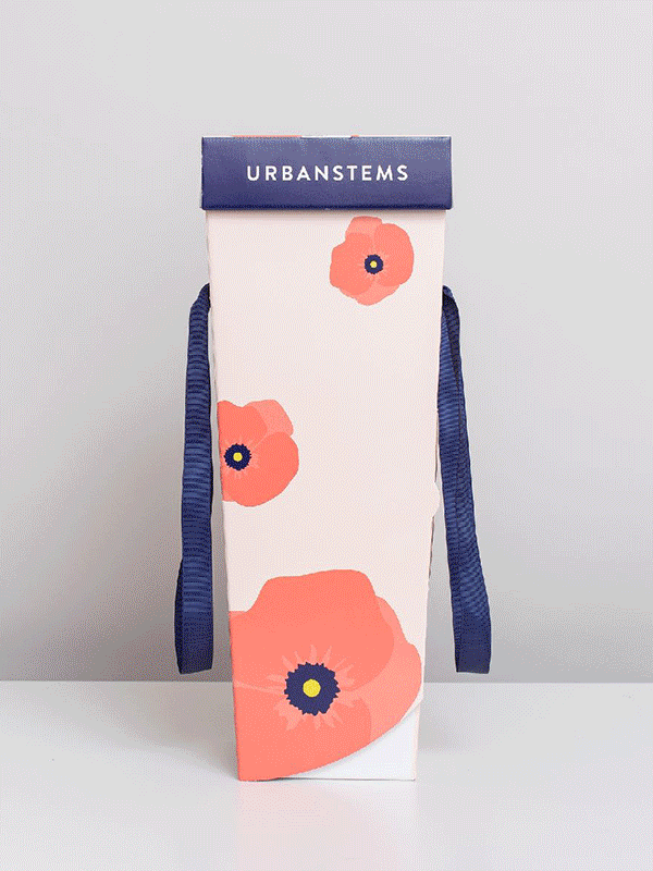 Final UrbanStems courier packaging — poppy print with navy ribbon